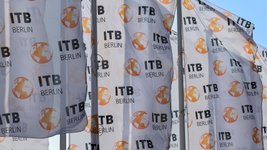 Fahnen mit der Aufschrift „ITB Berlin“ wehen im Wind.