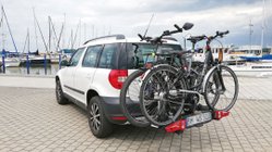 Weißes Auto am Hafen mit zwei Fahrrädern auf dem Fahrradträger.